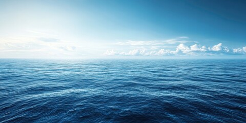 Obraz premium Vast ocean surface with gentle waves under a clear blue sky.