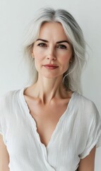 Fototapeta premium A woman with grey hair wearing a white shirt.