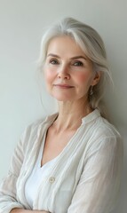 Fototapeta premium A mature woman with gray hair and a white shirt.