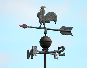 vintage metal weathervane featuring a rooster with a large tail on top along with an arrow and...