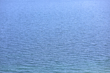 marine background with deep blue sea water and very few low waves