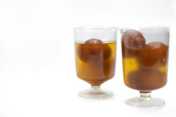 Indian dessert Gulab Jamun in transparent glass bowls.