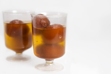 Close-up of delicious Gulab Jamun in transparent glass cups
