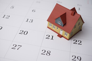 House on blank white calendar background copy space. Mortgage payment due, real estate property...