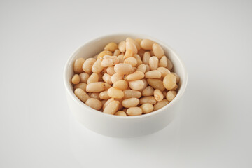 Shelled Pine Nuts: Close-Up of Roasted Siberian Seeds on a White Background
