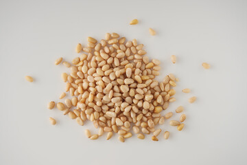 Shelled Pine Nuts: Close-Up of Roasted Siberian Seeds on a White Background