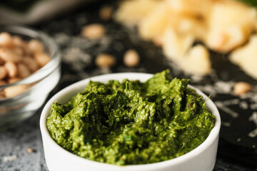 Homemade Pesto Sauce with Pine Nuts and Basil: Ingredients on Black Background