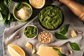 Homemade Pesto Sauce with Pine Nuts and Basil: Ingredients on Black Background
