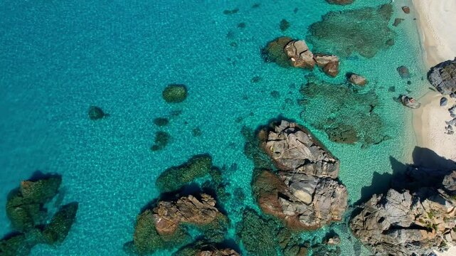 4K Aerial drone video of one of the most beautiful beaches in the world with turquoise clear blue water and white sand with big rocks on a sunny summer day. Marinella di Zambrone Paradiso Tropea Italy