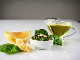Homemade Pesto Sauce with Pine Nuts and Basil: Ingredients on White Background