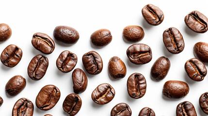 Close up of coffee beans with a white background. The beans are spread out in a pattern, with some overlapping and others not. Concept of warmth and comfort