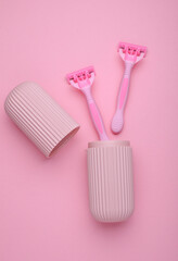 Organizer case with razors on pink background