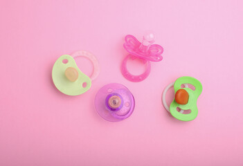 Newborn baby's pacifiers on a yellow background. Top view