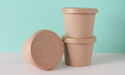Eco cardboard round food box on table, mint green background