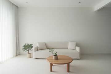 A serene, simple living space featuring soft white walls, a light-colored sofa, and a round wooden coffee table with a small plant. The room is spacious, with minimal decoration.