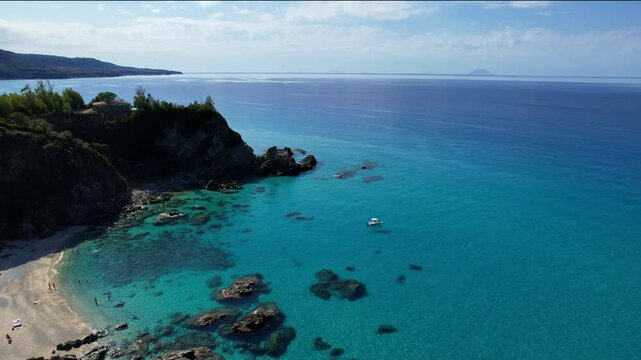 4K Aerial drone video of one of the most beautiful beaches in the world with turquoise clear blue water and white sand with big rocks on a sunny summer day. Marinella di Zambrone Paradiso Tropea Italy