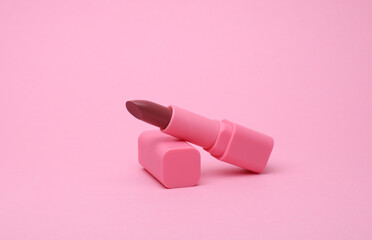 Pink lipstick tube on pink background
