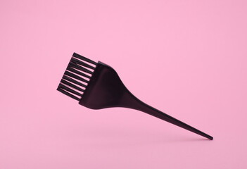 Hair dye brush floting on pink background