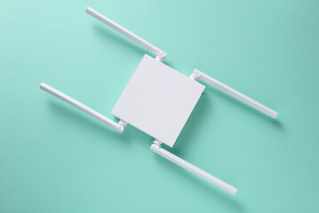 Modern white four-antenna Wi-Fi router on mint green background. Top view