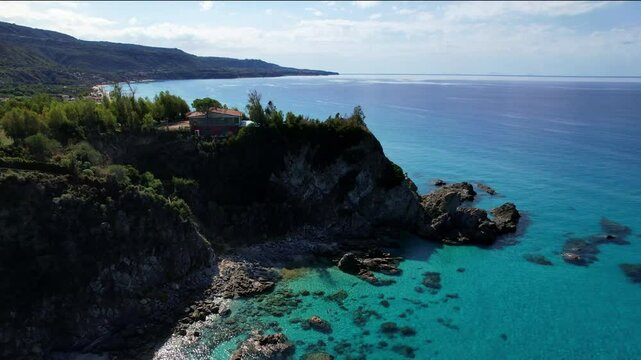 4K Aerial drone video of one of the most beautiful beaches in the world with turquoise clear blue water and white sand with big rocks on a sunny summer day. Marinella di Zambrone Paradiso Tropea Italy