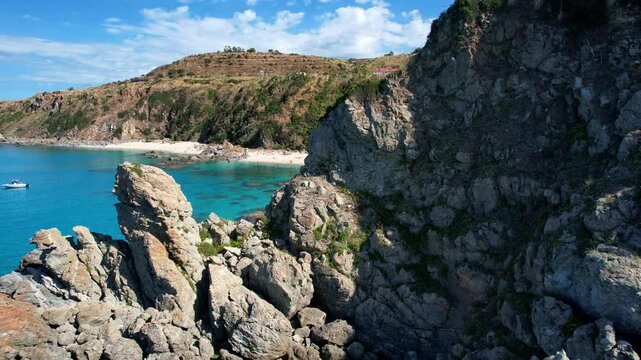 4K Aerial drone video of one of the most beautiful beaches in the world with turquoise clear blue water and white sand with big rocks on a sunny summer day. Marinella di Zambrone Paradiso Tropea Italy