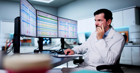 Unhappy Medical Doctor Doing Spreadsheet Codes