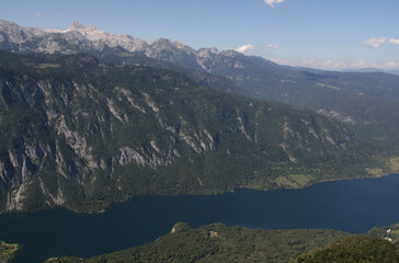 Landscape photo with the mountain range and Bohinjsko Lake against a blue sky with clouds in Triglav National Park, Slovenia	
