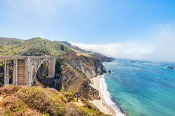 Beautiful scenery of Pacific Ocean coast along Highway 1 and Big Sur, wonderful aerial view of Bixby Bridge, sunset, sunrise, fog. Concept, travel, vacation, weekend