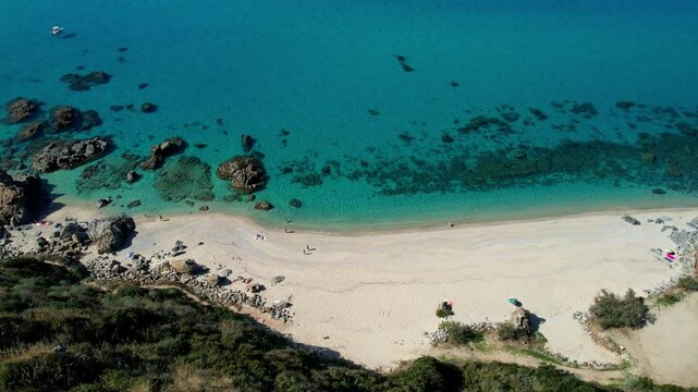4K Aerial drone video of one of the most beautiful beaches in the world with turquoise clear blue water and white sand with big rocks on a sunny summer day. Marinella di Zambrone Paradiso Tropea Italy