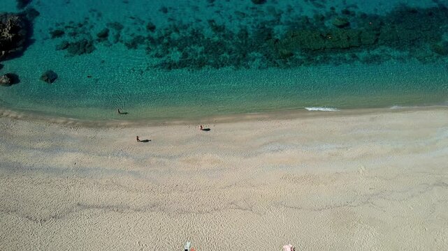 4K Aerial drone video of one of the most beautiful beaches in the world with turquoise clear blue water and white sand with big rocks on a sunny summer day. Marinella di Zambrone Paradiso Tropea Italy