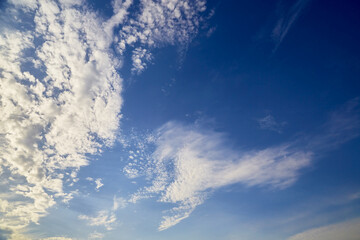 Morning blue sky with wispy clouds.