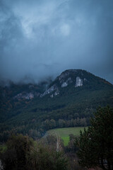 Fototapeta premium A photo of a mountain with a large rock in the middle