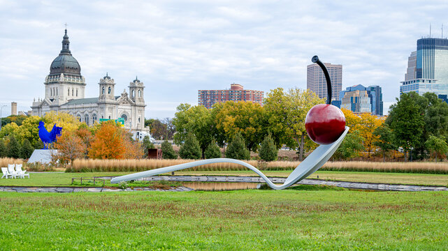 A close up image of Spoonbridge and Cherry at sculpture garden with giant blue rooster and Catholic church at background,, Minneapolis at fall season