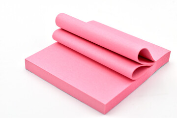 Red sticky notes with adhesive strips lie on a white background.