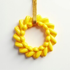 Obraz premium Yellow wreath-shaped Christmas tree ornament, smooth and glossy, set against a white background. Realistic and festive for holiday decorating.