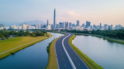 Fototapeta premium A curving highway disappearing into a tranquil urban skyline, surrounded by greenery and water bodies under a clear sky, urban roads, serene atmosphere