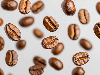 Falling realistic coffee beans isolated on transparent background. Flying defocusing coffee grains. Applicable for cafe advertising, package, menu design 