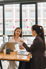 Engaged women discussing ideas in modern office setting, showcasing collaboration and creativity. Their expressions reflect enthusiasm and teamwork