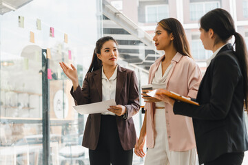 Empowered women engage in collaborative meeting, discussing ideas and strategies in modern office...