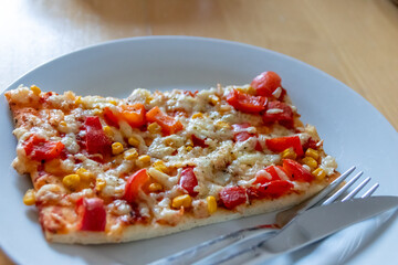 Authentic delicious slice of vegetarian pizza for healthy lifestyle of vegetarians and vegans with fast food snack as piece of pizza with paprika and sweet corn and cheese topping as delicious snack