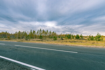 Fototapeta premium A road with a few trees in the background
