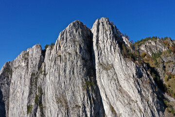 Aerial view of rocky limestone mountains and autumn forest