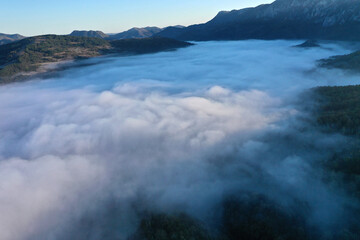 Aerial view of autumn morning mist and clouds in the valley