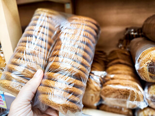 Delicious cookies in your hand at the store. Selection and purchase. Weight loss, healthy lifestyle, body positive