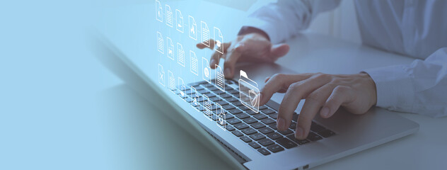 A person types on a laptop keyboard with digital icons of documents and folders representing online insurance management.