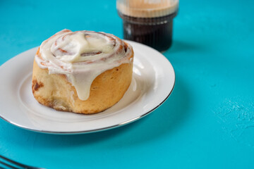Traditional northern European dessert Cinnamon roll on plate on wooden background
