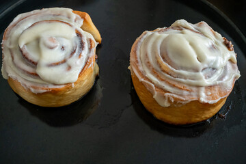 Traditional northern European dessert Cinnamon roll on plate on wooden background