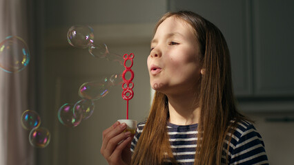 Caucasian European little girl blowing soap bubbles daughter child childhood fun enjoyment smile happy female play time kid baby bubble joyful vacations toy dream foam game magic imagination innocence