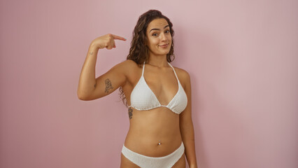 Fototapeta premium Young woman pointing to herself over an isolated pink background showcasing confidence and beauty