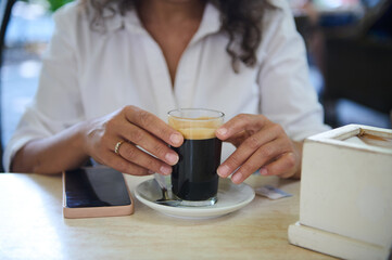 Woman enjoying a relaxing coffee break at a cafe